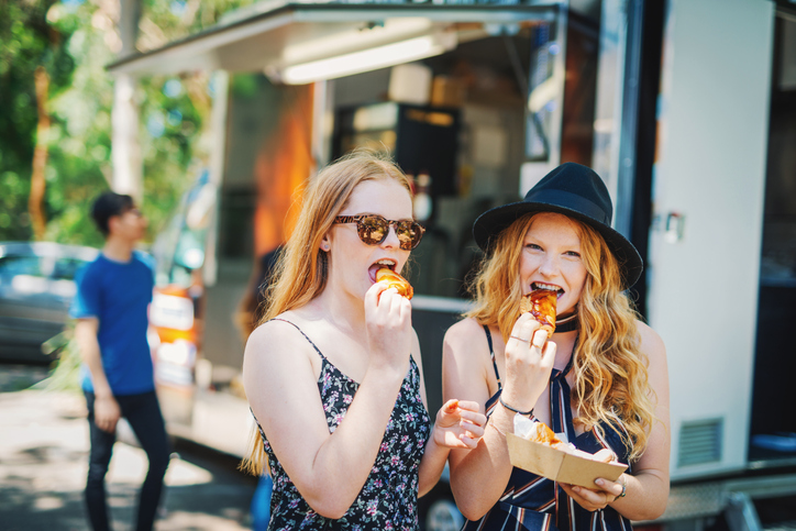 EATS Street is a true treat of South Walton Beaches Food & Wine Festival two redhead girls eating food from a food truck