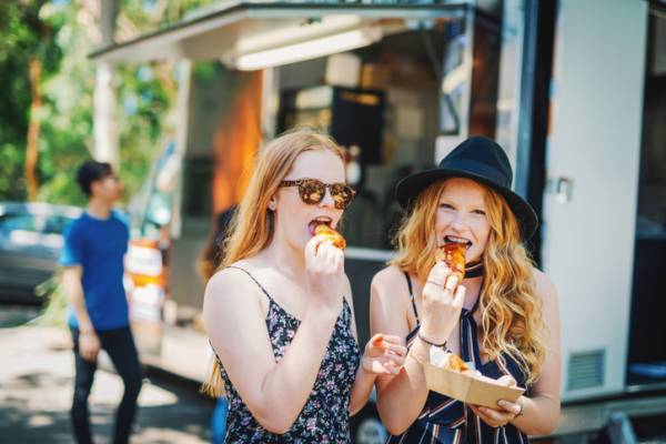 EATS Street is a true treat of South Walton Beaches Food & Wine Festival two redhead girls eating food from a food truck