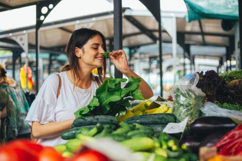 30A Farmers Market - Rosemary Beach, Niceville & Sandestin young woman smelling fresh basil at a farmers market